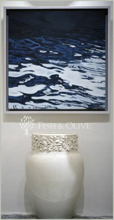 Photo from inside the Fish & Olive Gallery showcasing a photo taken by Alexander and a beautiful vase created by Katharina Bolesch